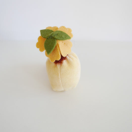 Small plush toy resembling a flower on a white background