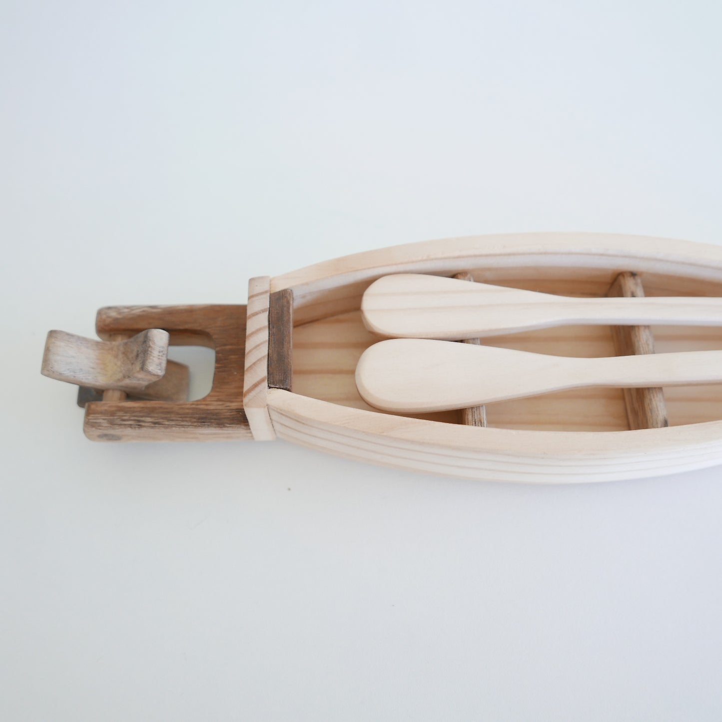 wooden toy boat with oars for play