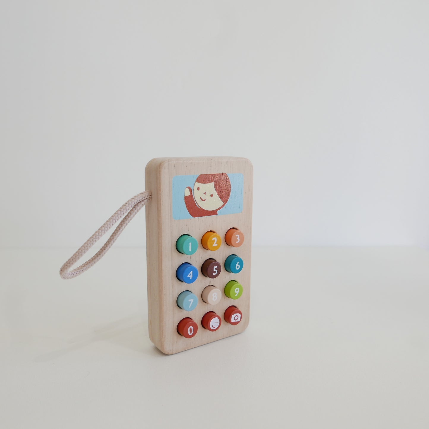 Wooden toy phone with colorful buttons