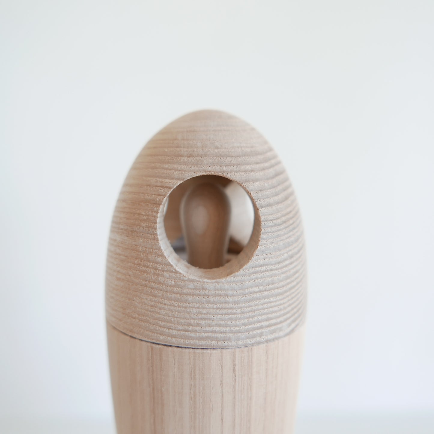 Wooden toy with a cylindrical design on a white background