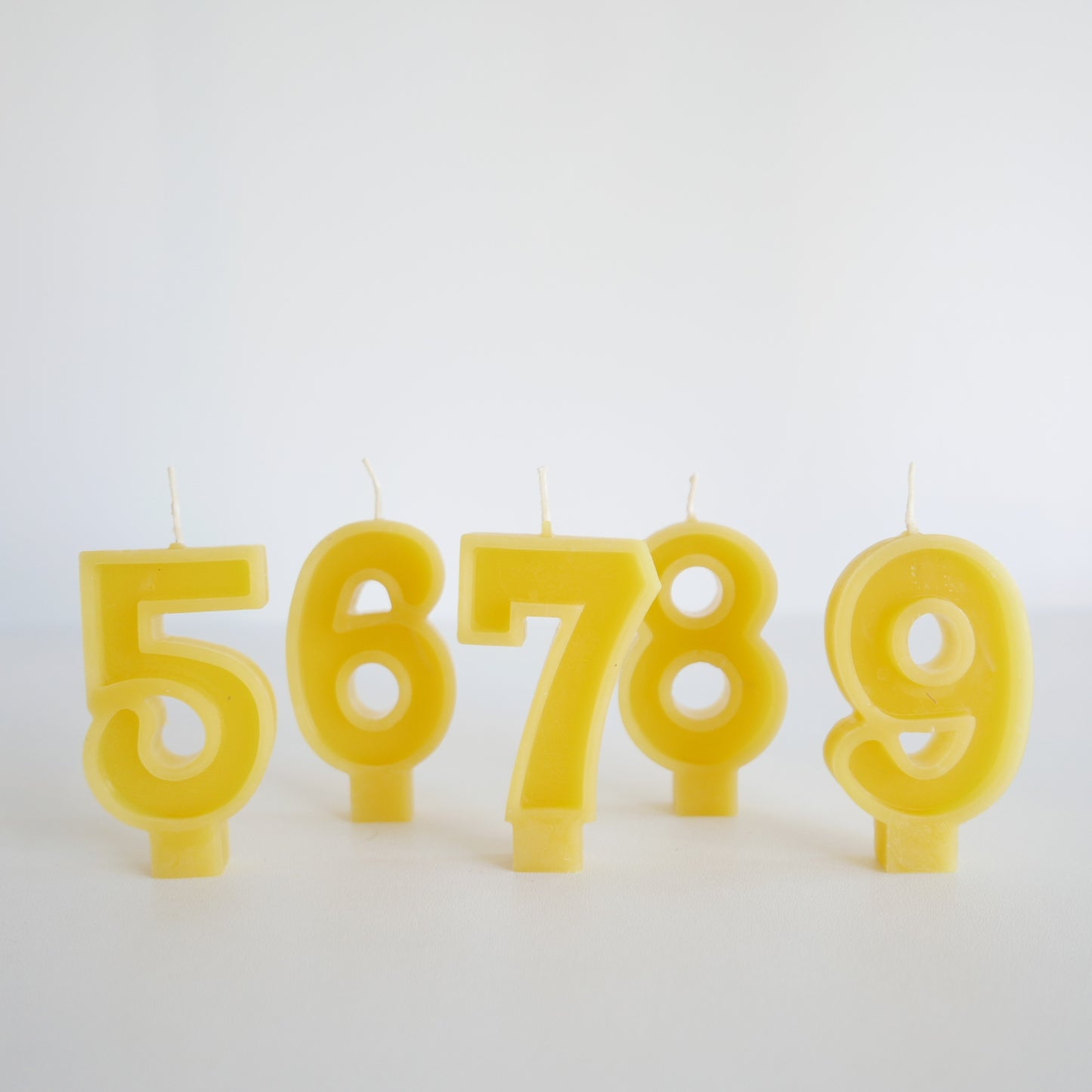 Set of yellow beeswax number candles for birthdays

