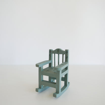 Small green rocking chair on a white background