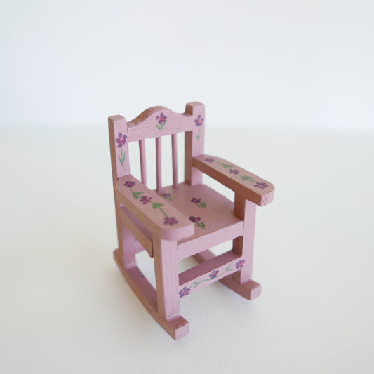 Miniature wooden rocking chair painted in soft primrose yellow, designed for a dolls’ house, photographed on a white background