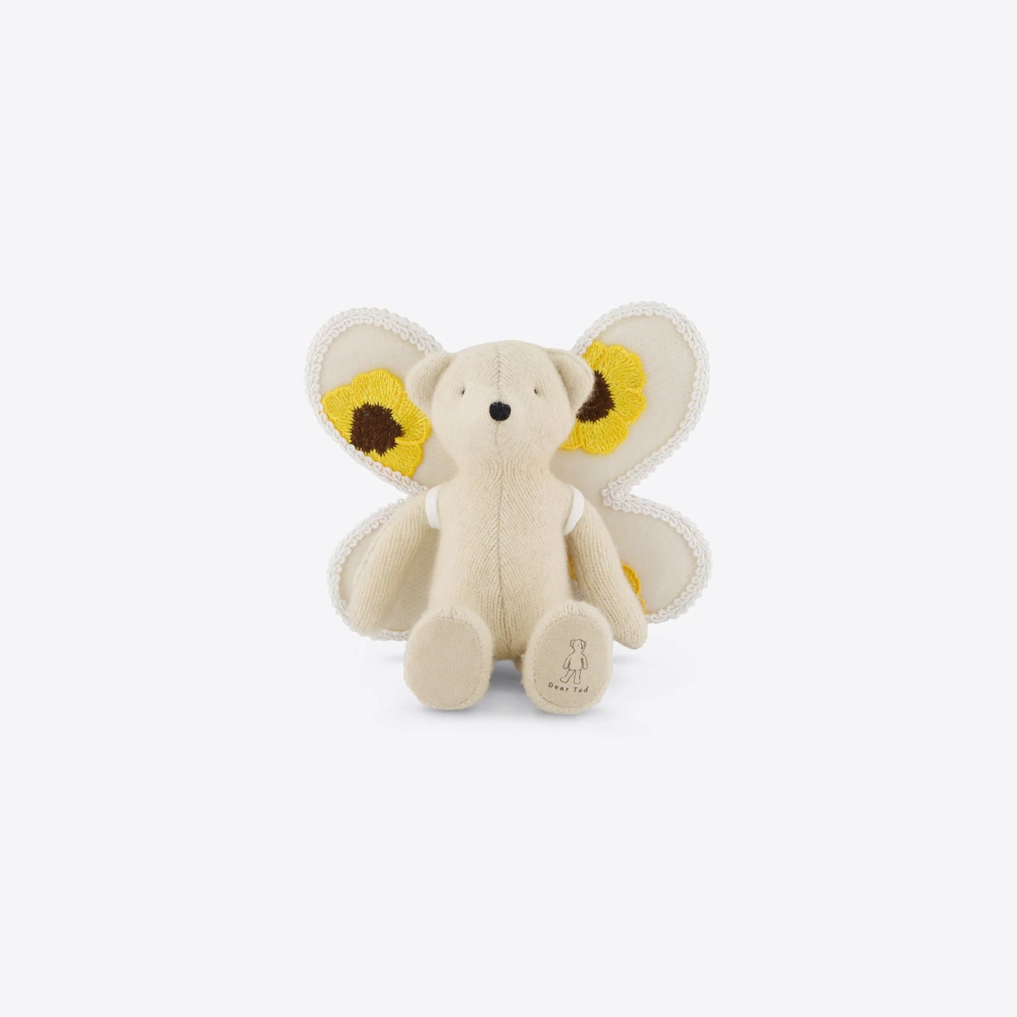Stuffed toy teddy with yellow butterfly wings on a white background
