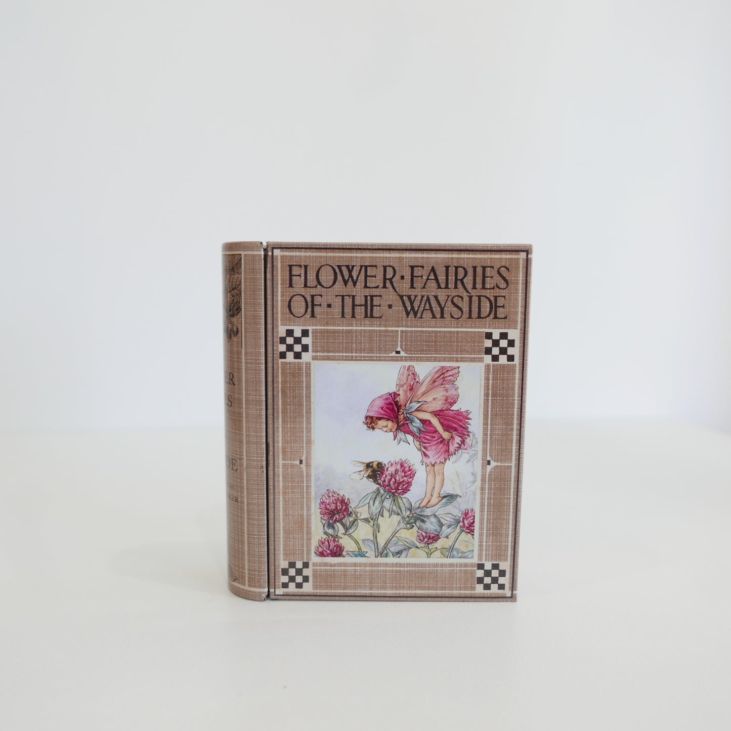 Book titled 'Flower Fairies of the Wayside' with a fairy illustration on the cover against a white background