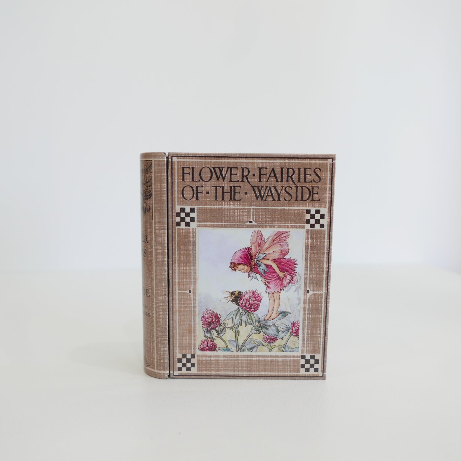 Book titled 'Flower Fairies of the Wayside' with a fairy illustration on the cover against a white background