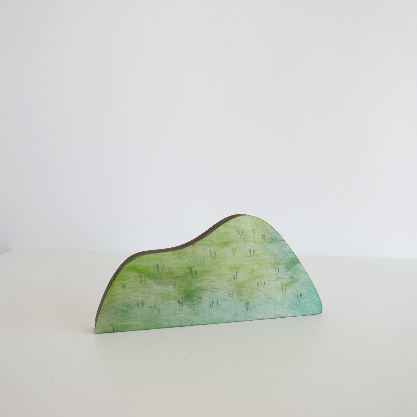 Green decorative piece on a white background