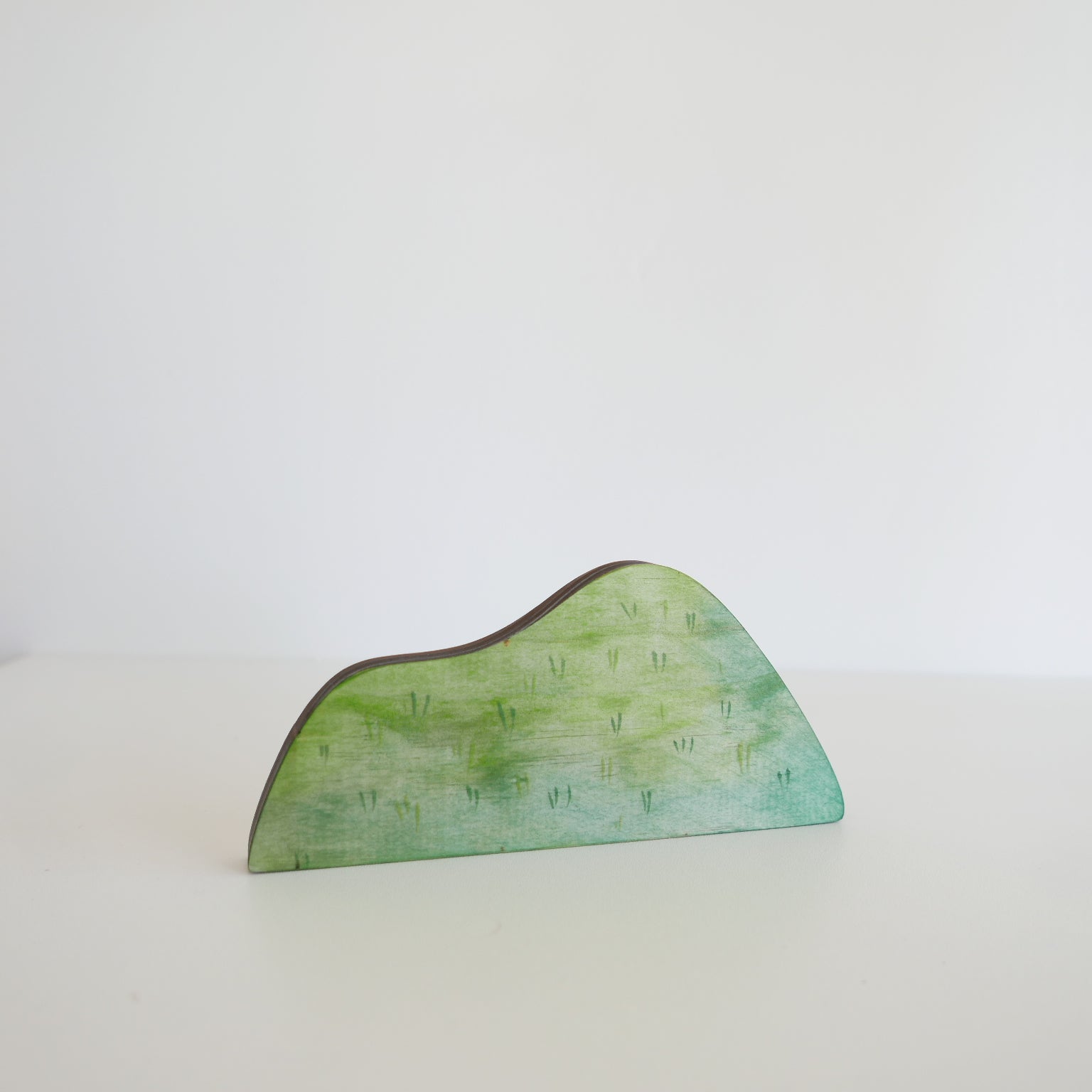 Green decorative piece on a white background