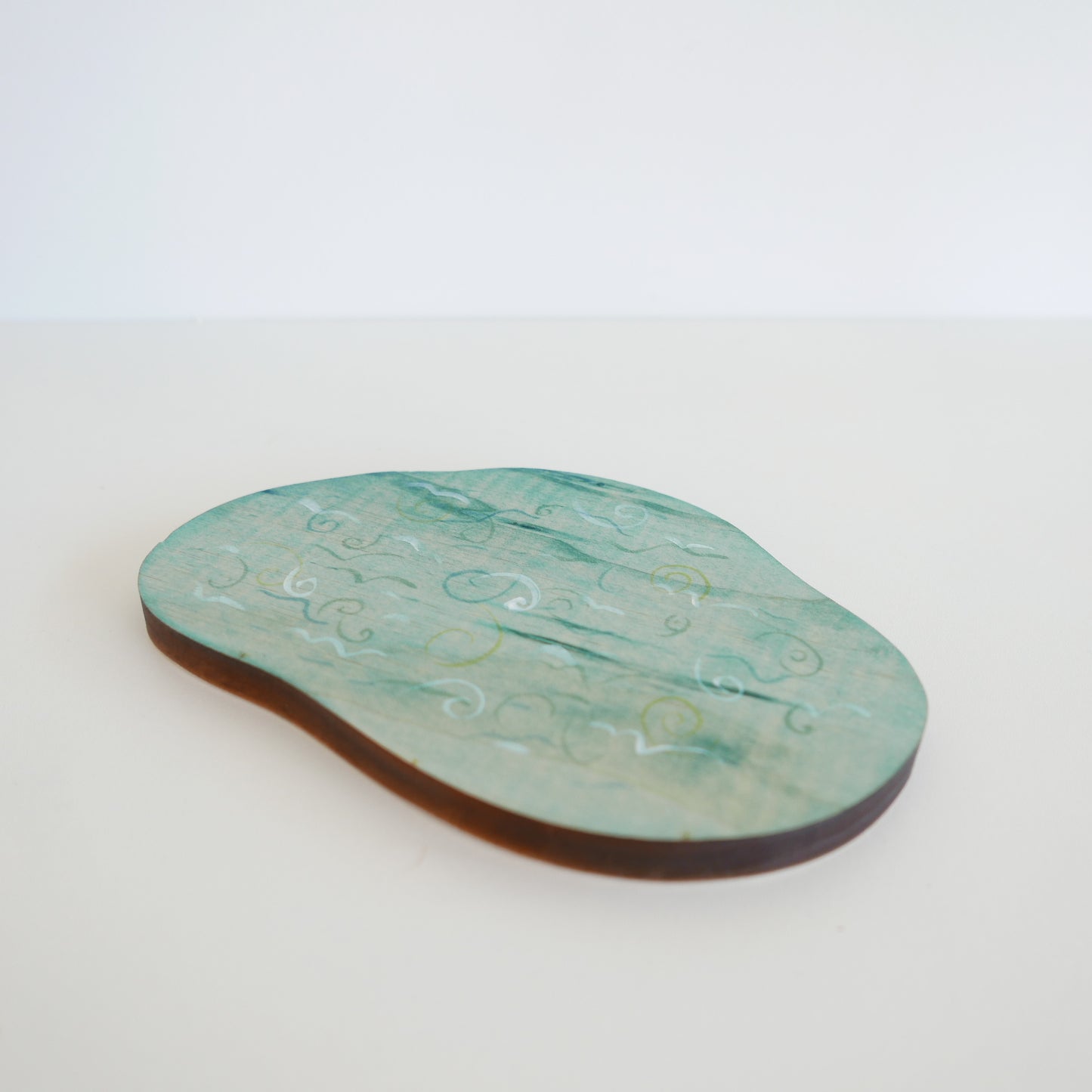 Handcrafted blue wooden lake toy with organic curved edges, designed for imaginative landscape scenes, displayed against white