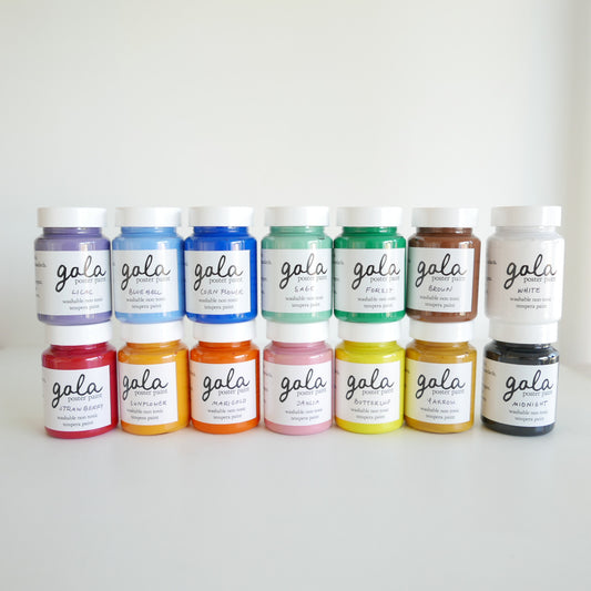 Row of Gala paint jars in various colors on a white background