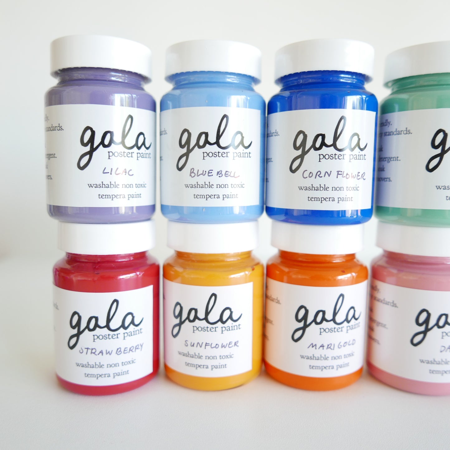 Jars of Gala poster paint in various colors on a white background