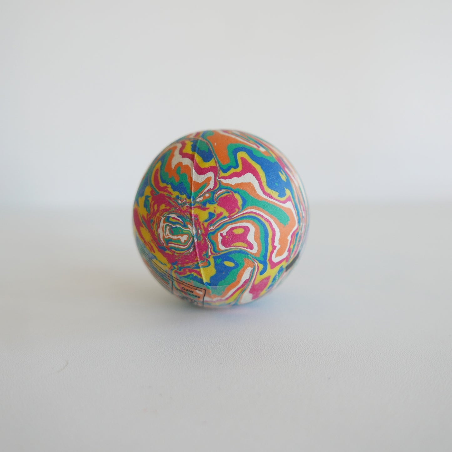 Colorful marbled bouncy ball on a white background