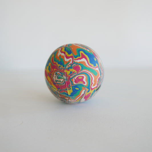 Colorful marbled bouncy ball on a white background