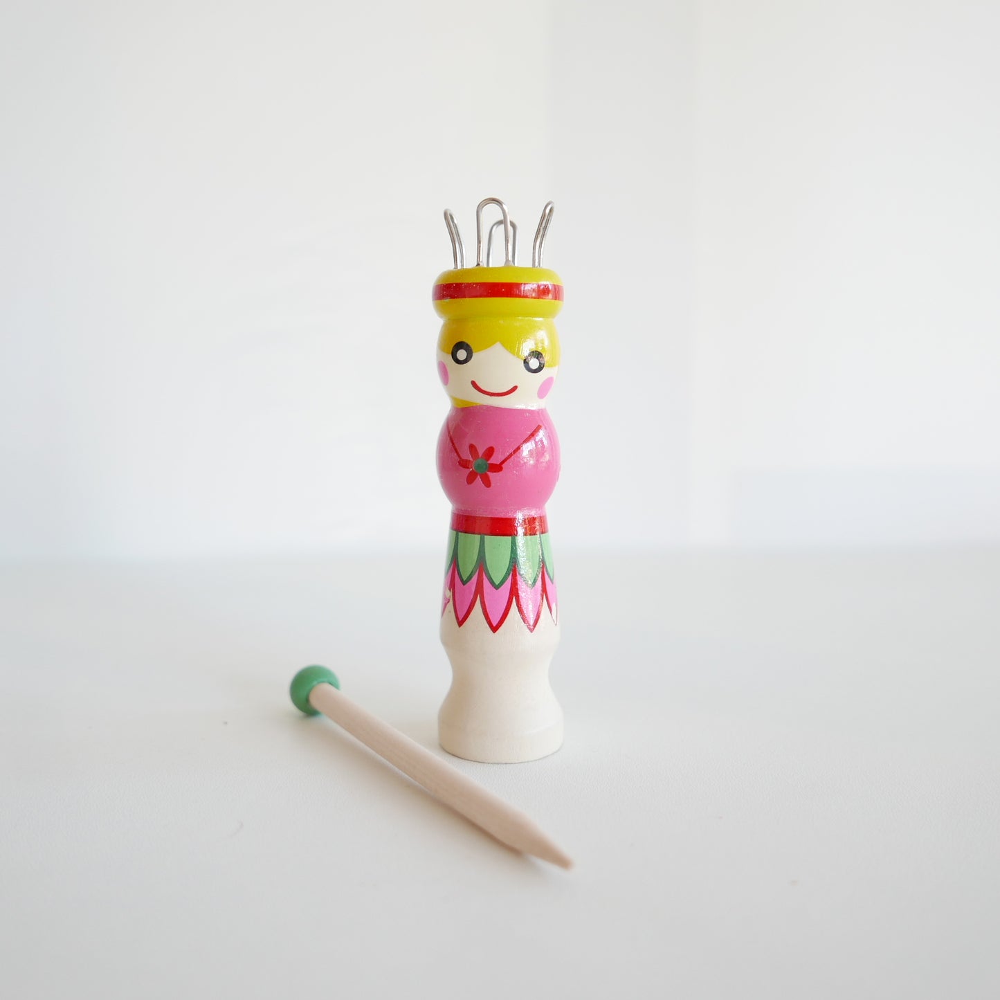 Wooden French knitting dolly and needle, suitable for kids’ craft activities, isolated on white backdrop