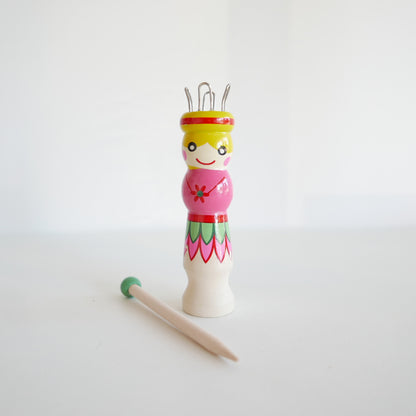 Wooden French knitting dolly and needle, suitable for kids’ craft activities, isolated on white backdrop