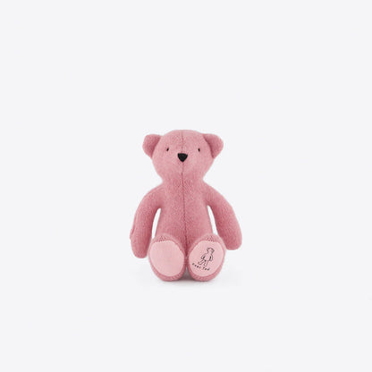Plush Little Ted bear in pastel pink with embroidered face, crafted for comfort and imaginative play, displayed against white