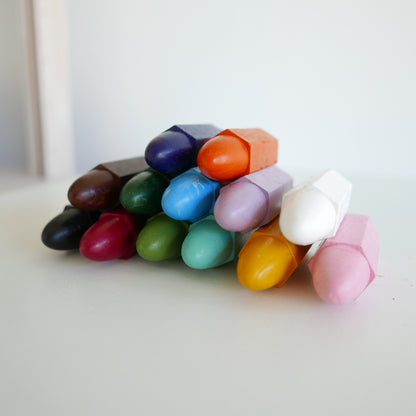Assorted colorful crayons on a white surface