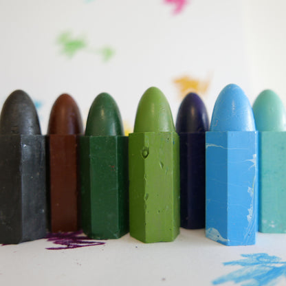Set of colorful crayons on a white background with artistic smudges.