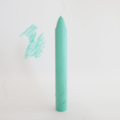 Mint green crayon on a white background with a small drawing of a horse.