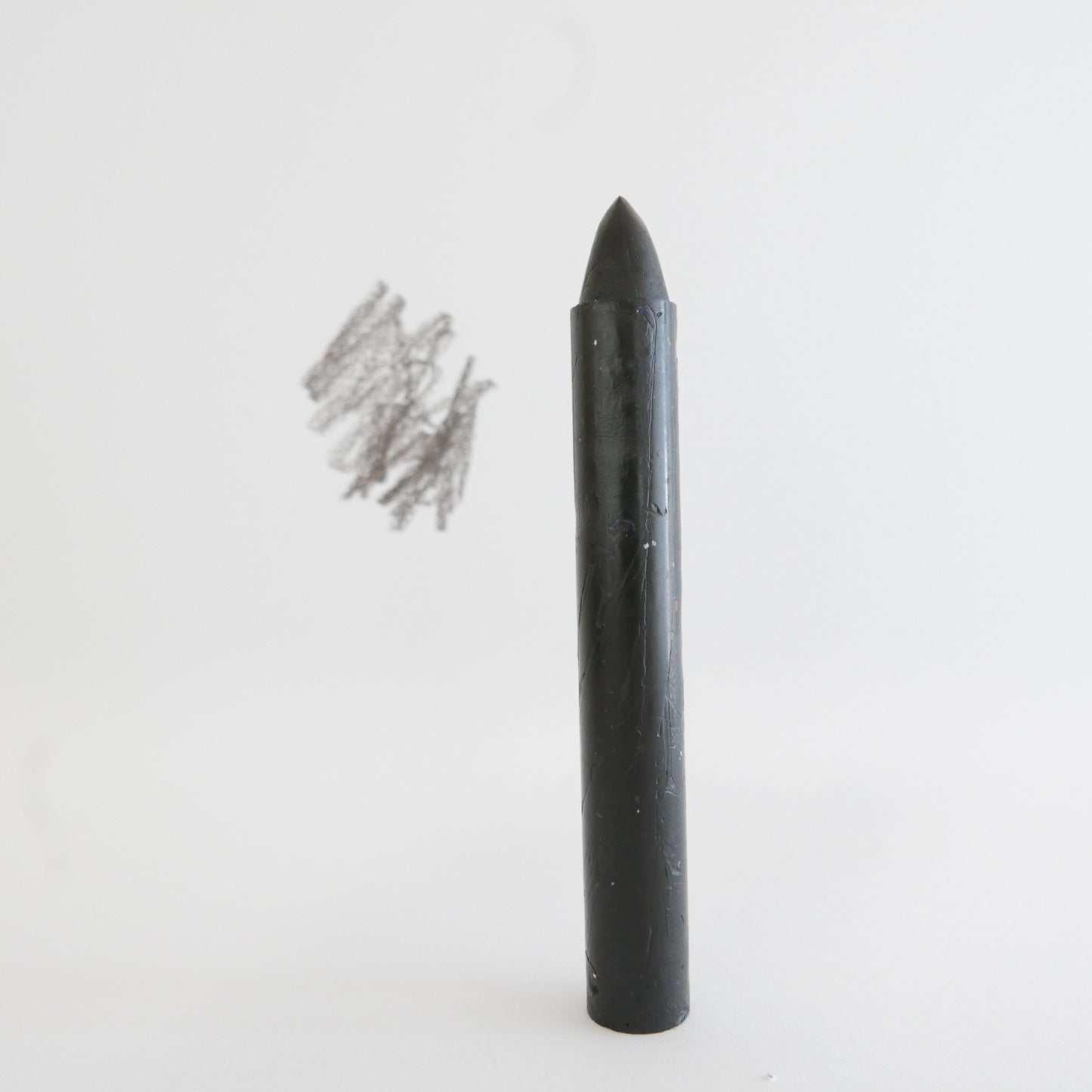 Black crayon produced in New Zealand displayed alone
