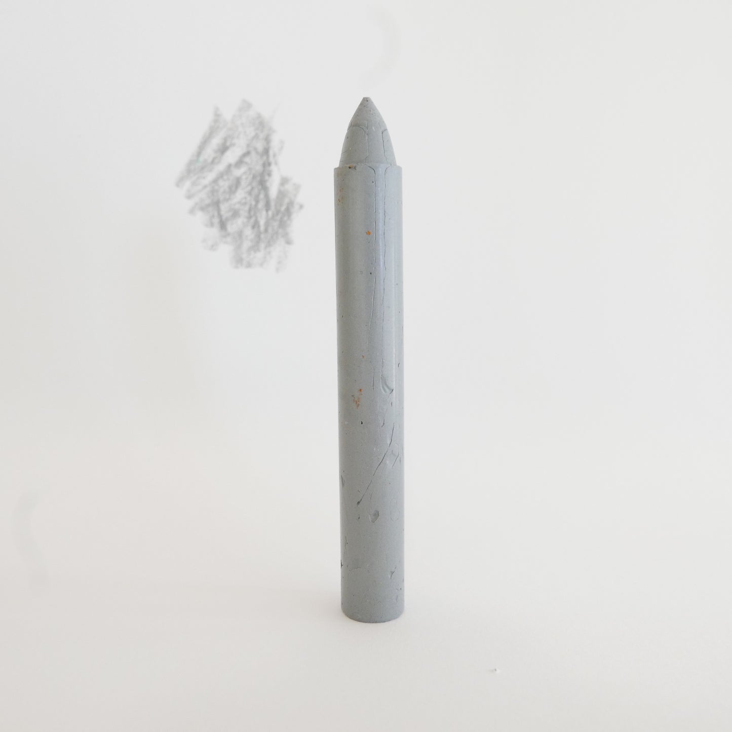 Gray cylindrical crayon on a white background