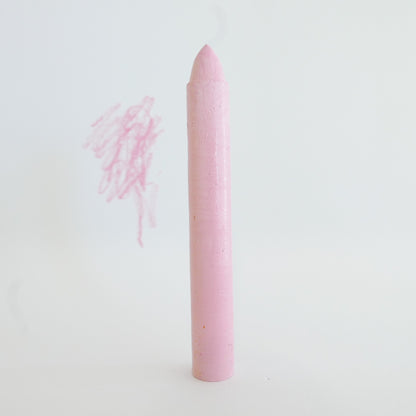 Pink crayon on a white background