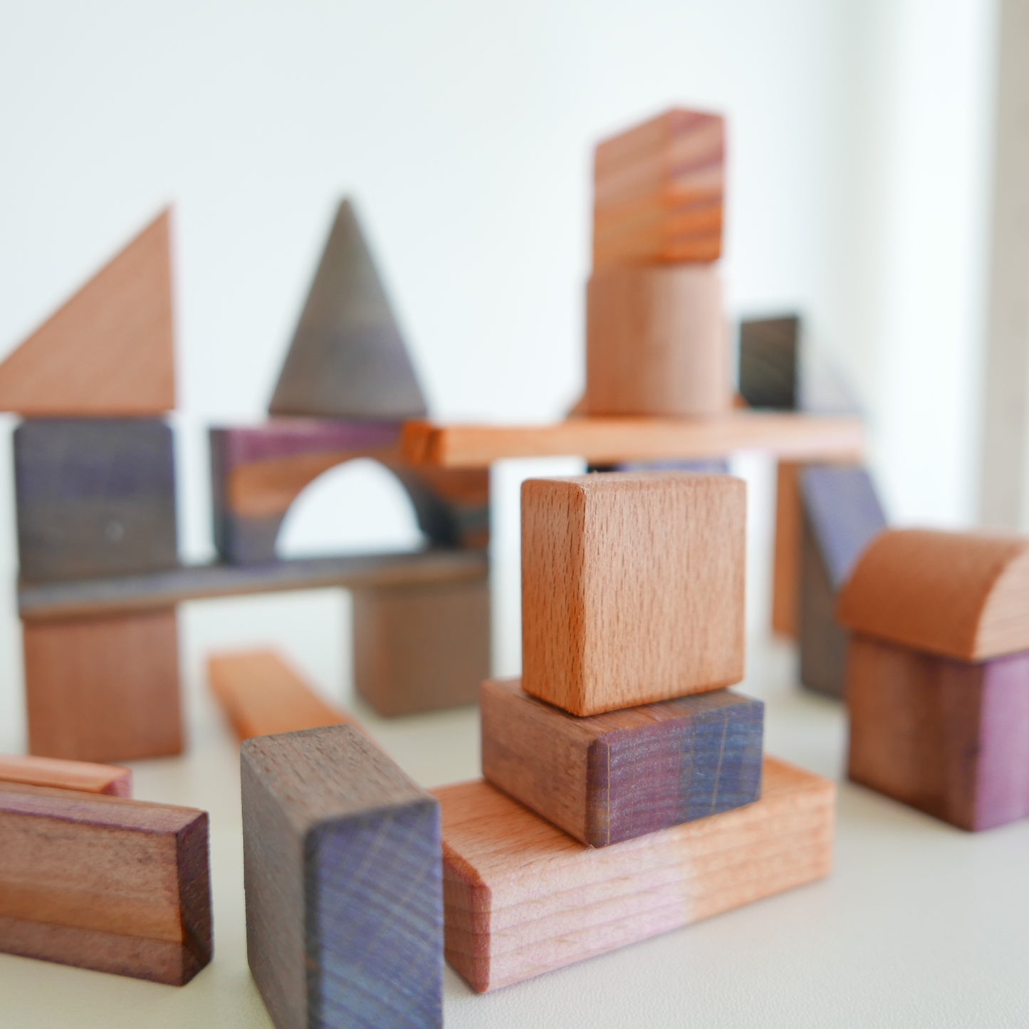 Set of colorful wooden Rothko blocks arranged in abstract patterns, photographed on a white background