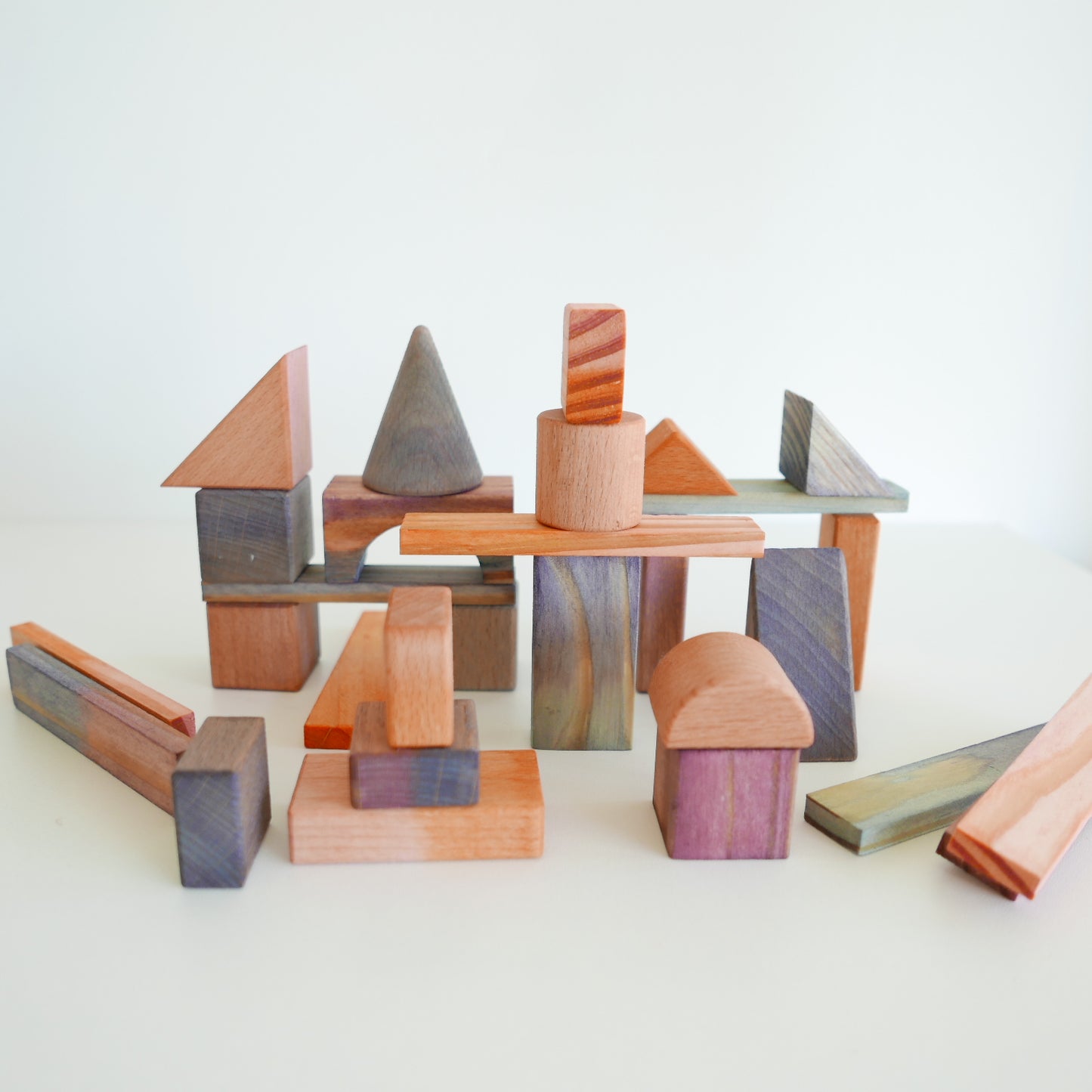 Children’s toy: painted wooden blocks in bold primary colors, ideal for creative play and stacking, isolated on white