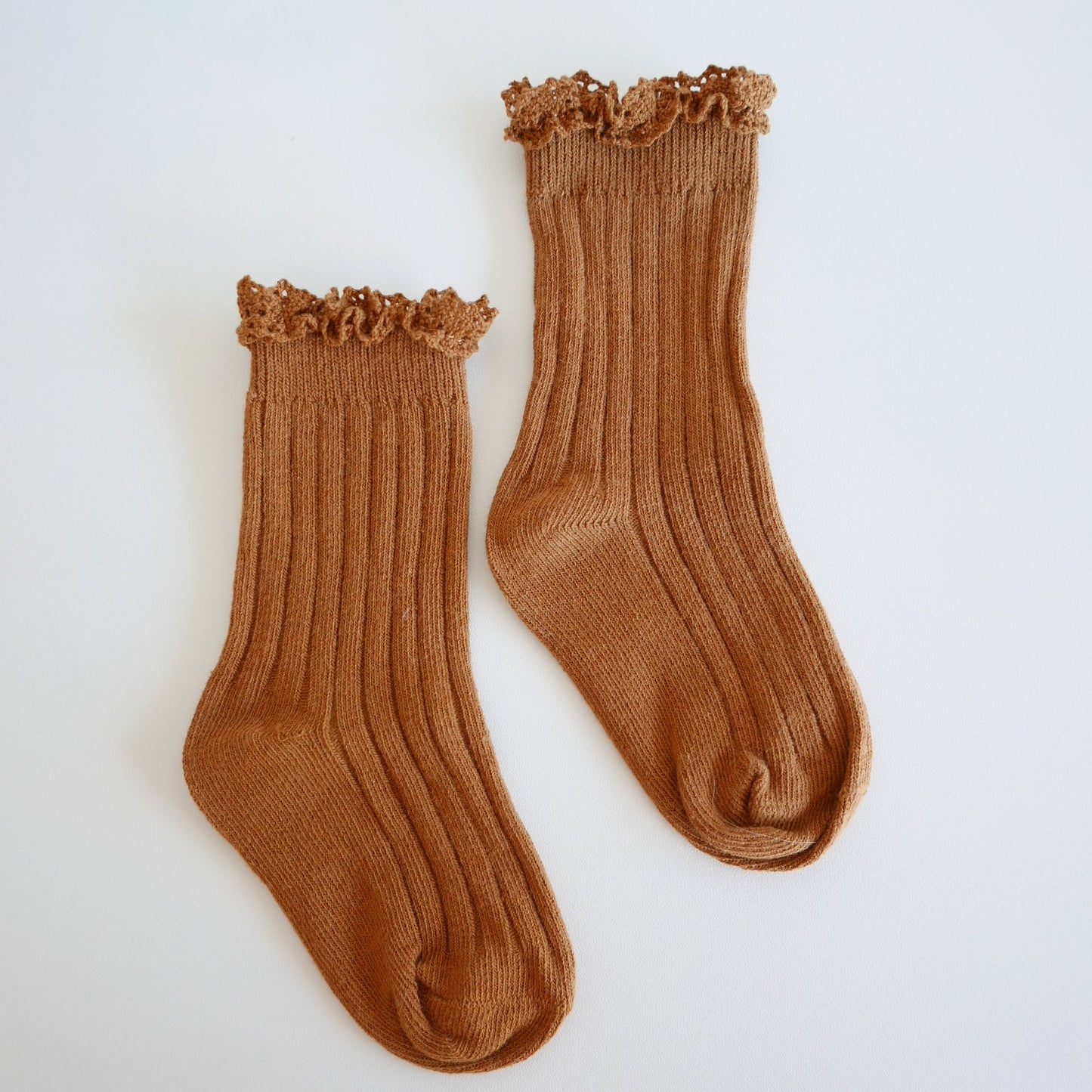 Pair of brown socks on a white background