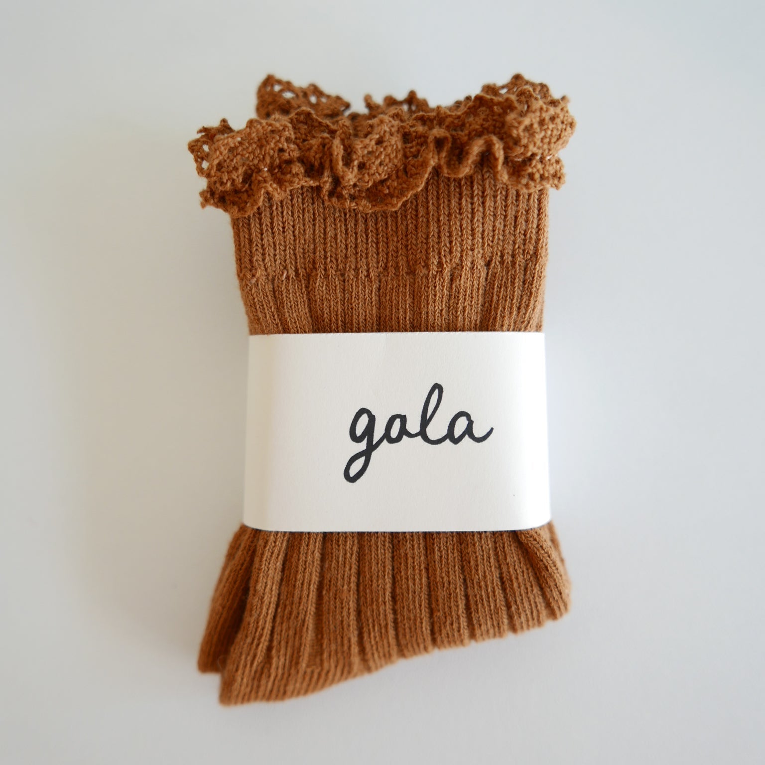 Brown ribbed socks with ruffled top on a white background, featuring the brand 'gala'.