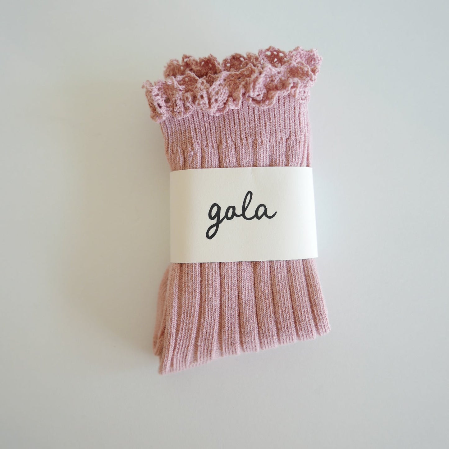 Pink lace socks with 'gala' label on a light gray background