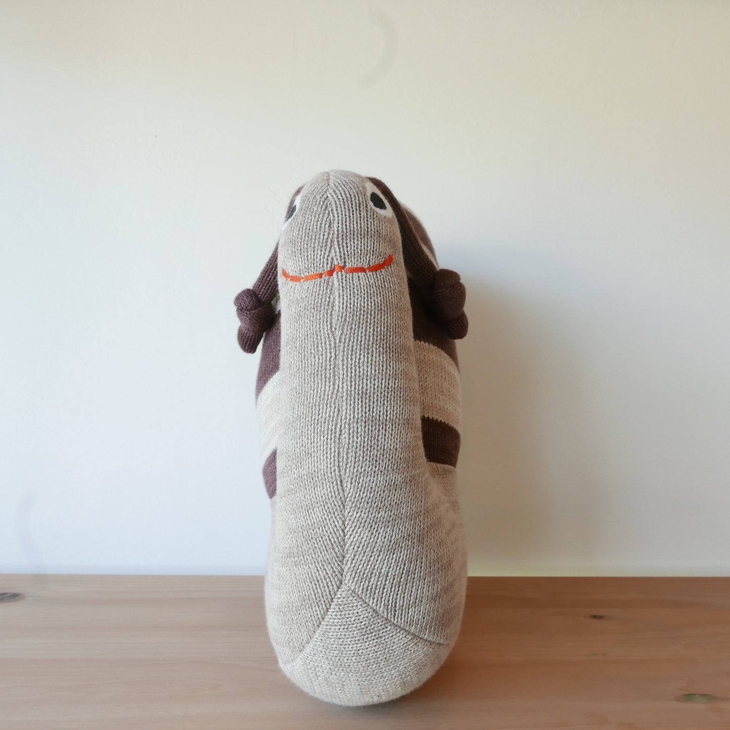 Close up of Sally Snail soft toy with embroidered details
