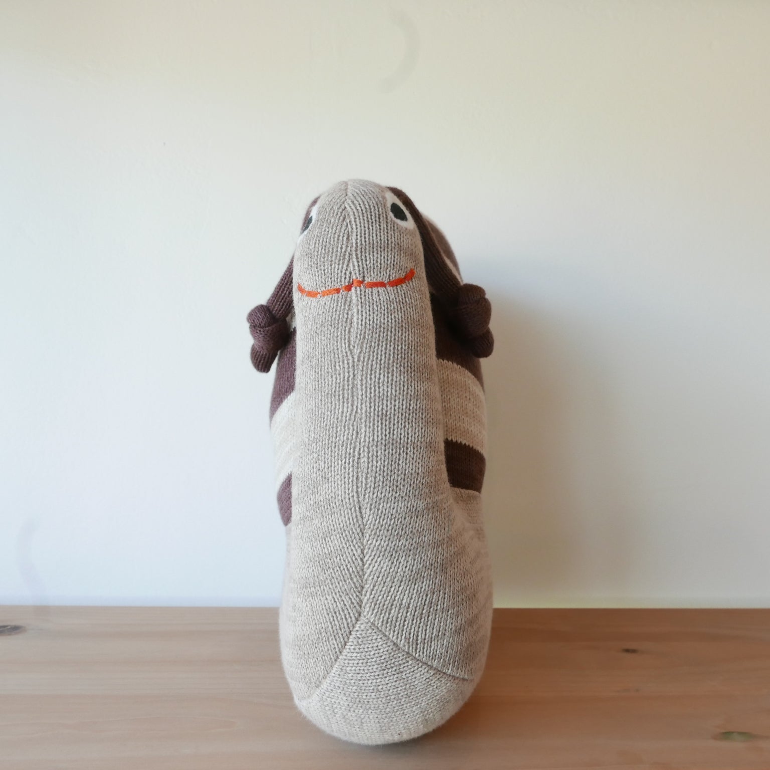 Close up of Sally Snail soft toy with embroidered details
