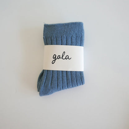 Blue sock with a 'gala' label on a light gray background