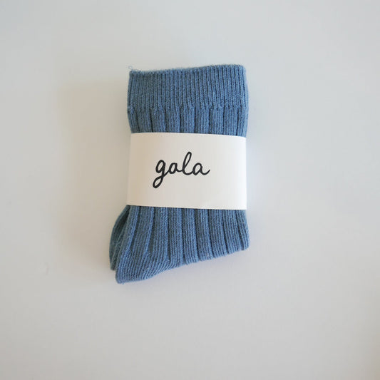 Blue sock with a 'gala' label on a light gray background