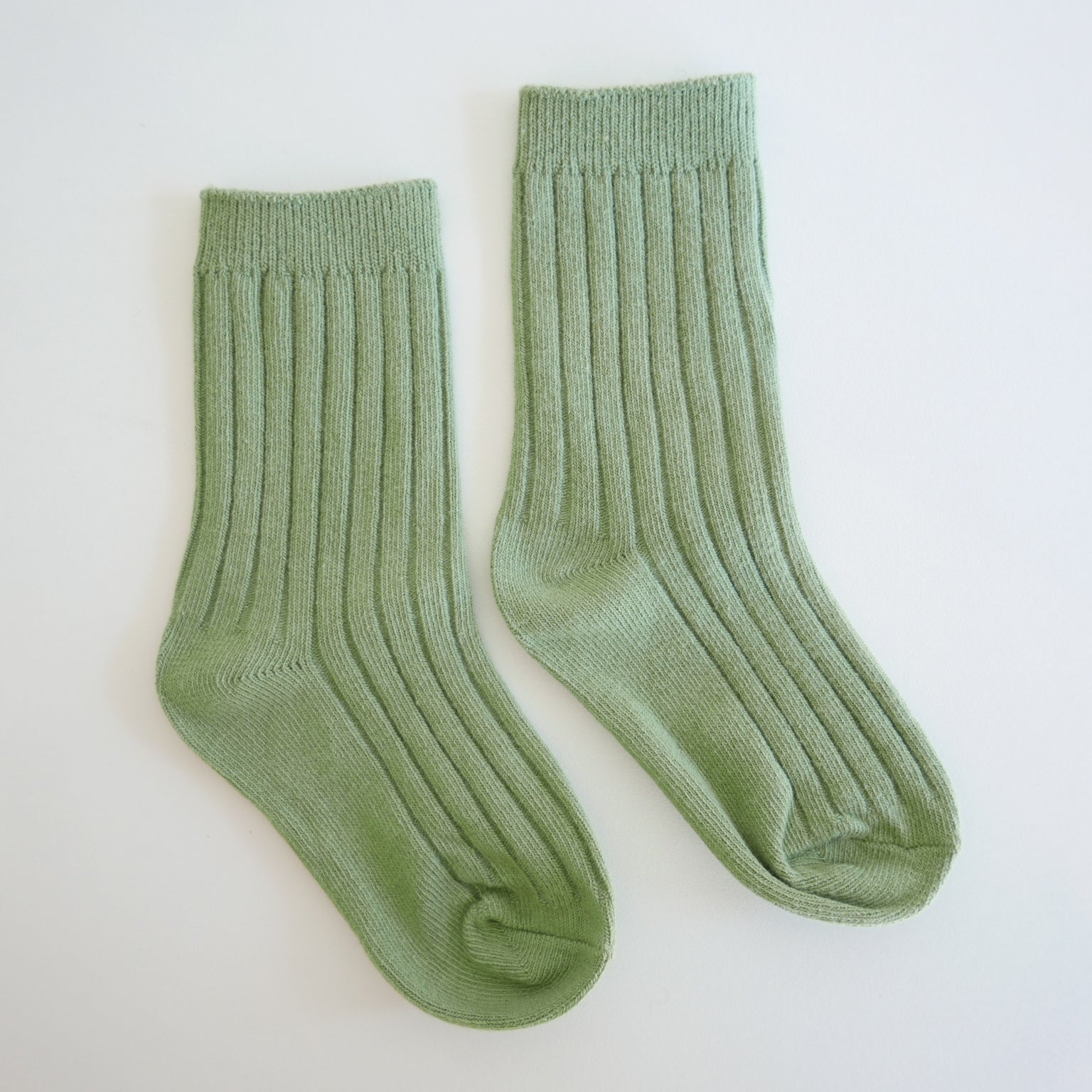 Pair of green socks on a white background
