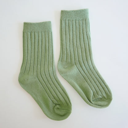 Pair of green socks on a white background