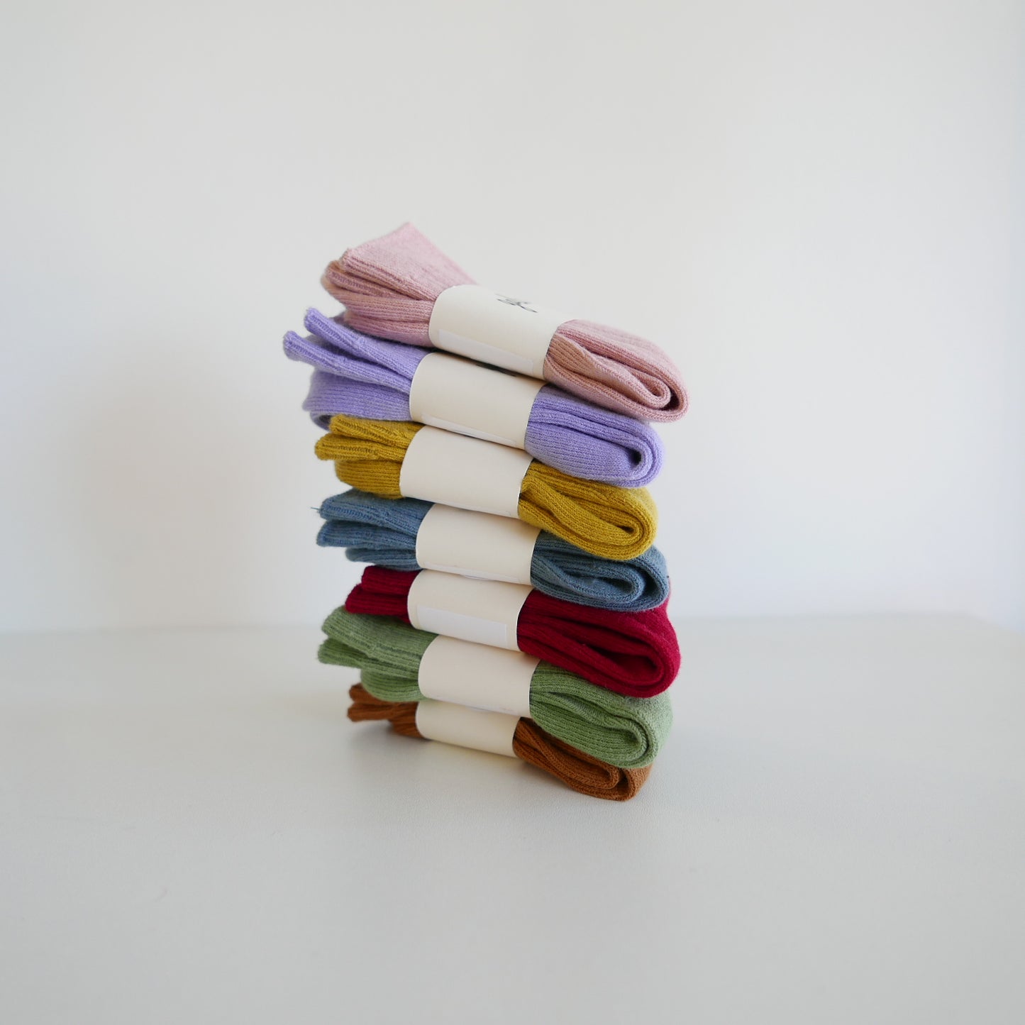 Stack of colorful socks on a white background