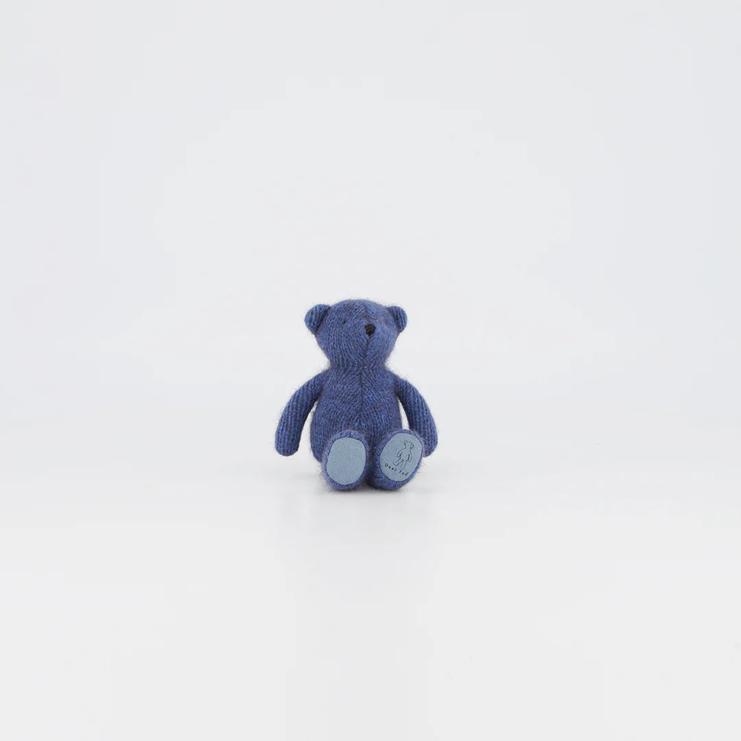 Tiny Ted Periwinkle, a handcrafted soft toy bear in pastel blue, perfect for snuggling and gifting, isolated on white