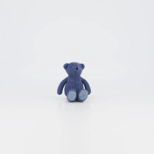 Tiny Ted Periwinkle, a handcrafted soft toy bear in pastel blue, perfect for snuggling and gifting, isolated on white