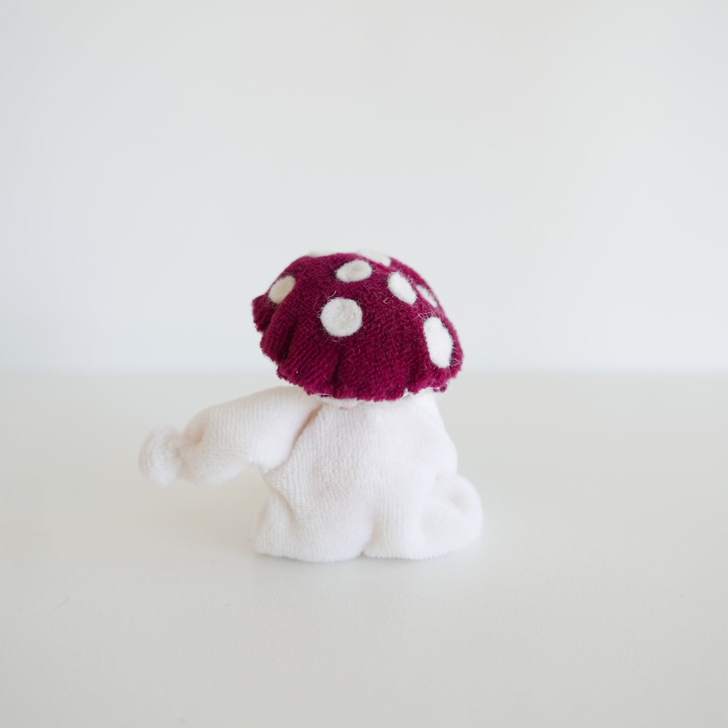 Unique fabric Toadstool Poppit Doll with mushroom cap and playful expression, ideal for children’s imaginative play, isolated on white