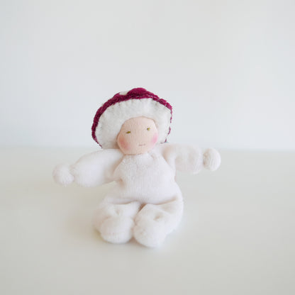 Whimsical plush doll with toadstool hat and pastel-colored clothing, designed for pretend play and storytelling, displayed against white