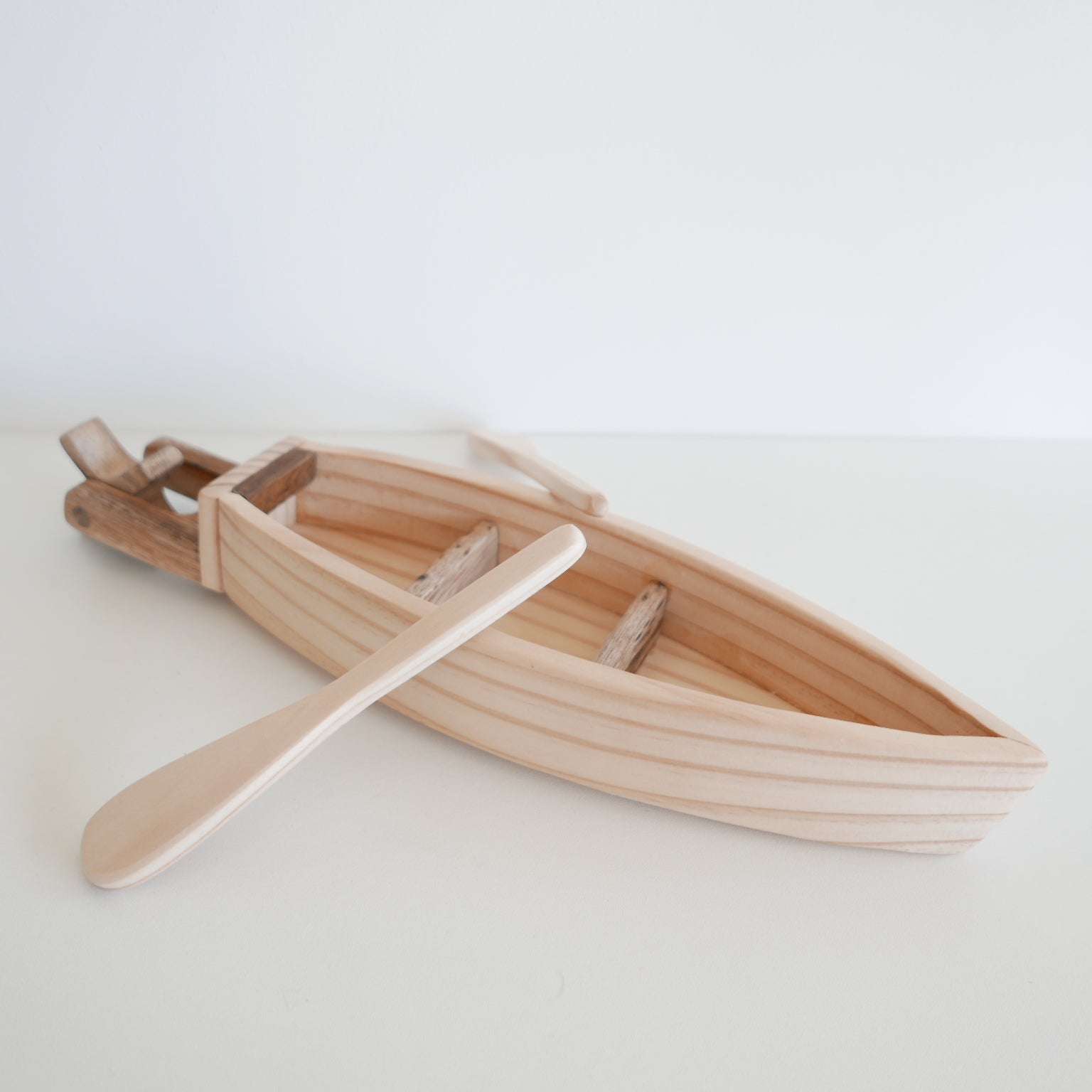 Wooden toy boat with a paddle for children
