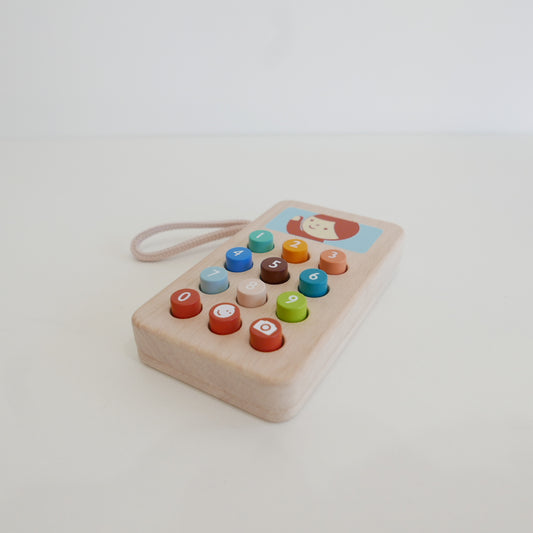 Wooden toy phone with colorful buttons 