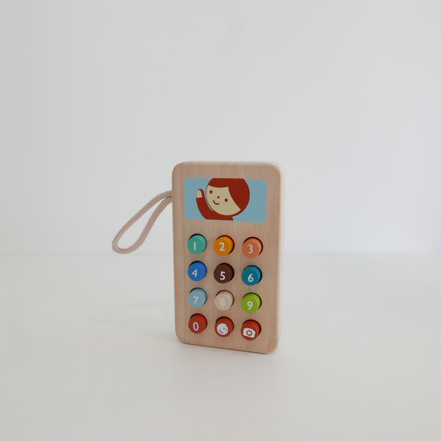 Wooden toy phone with colorful buttons 