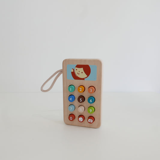 Wooden toy phone with colorful buttons 