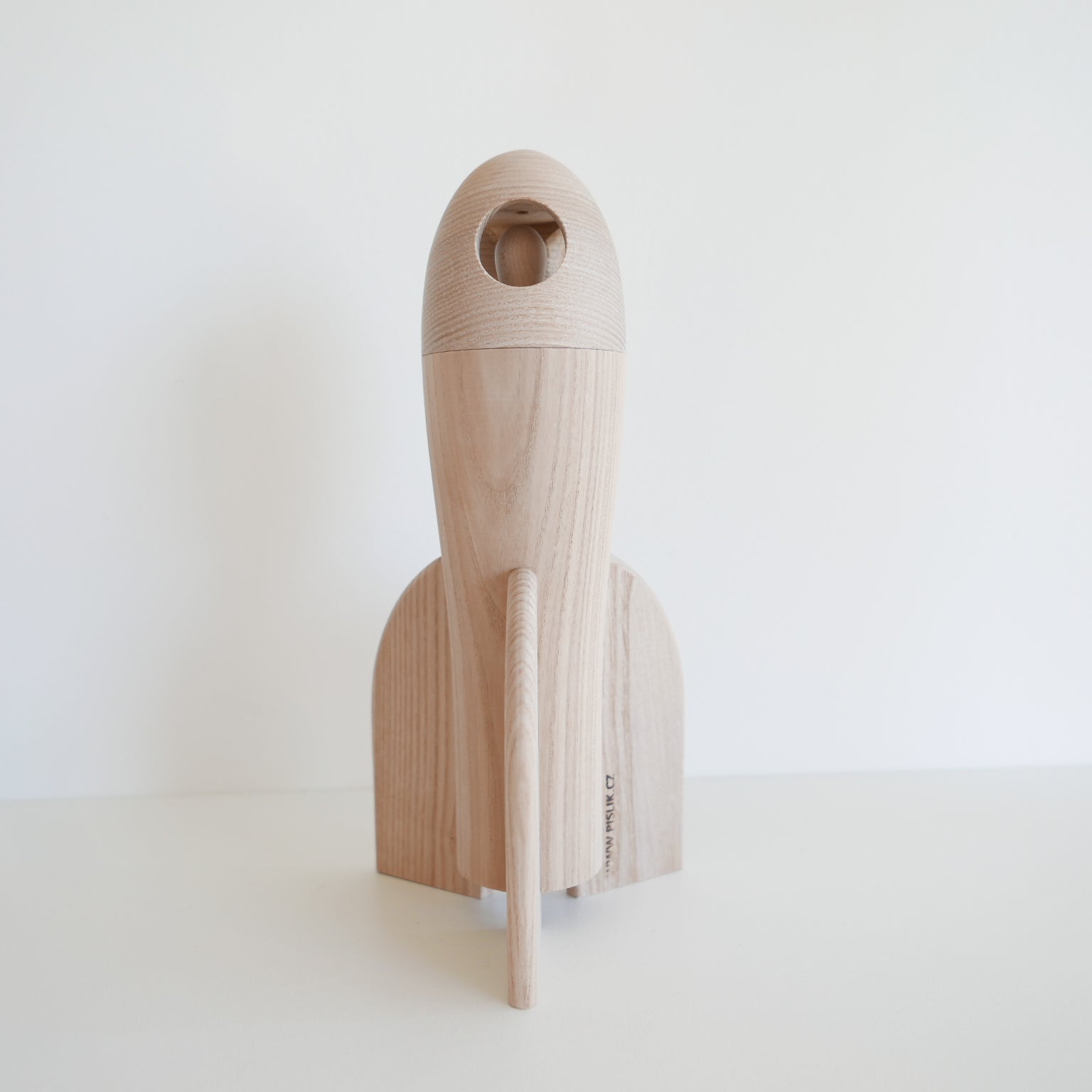 Wooden tool with a handle and blade on a white background