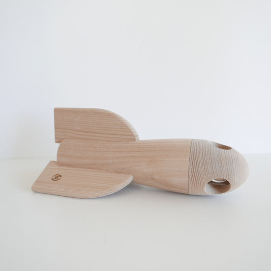 Wooden toy fish on a white background