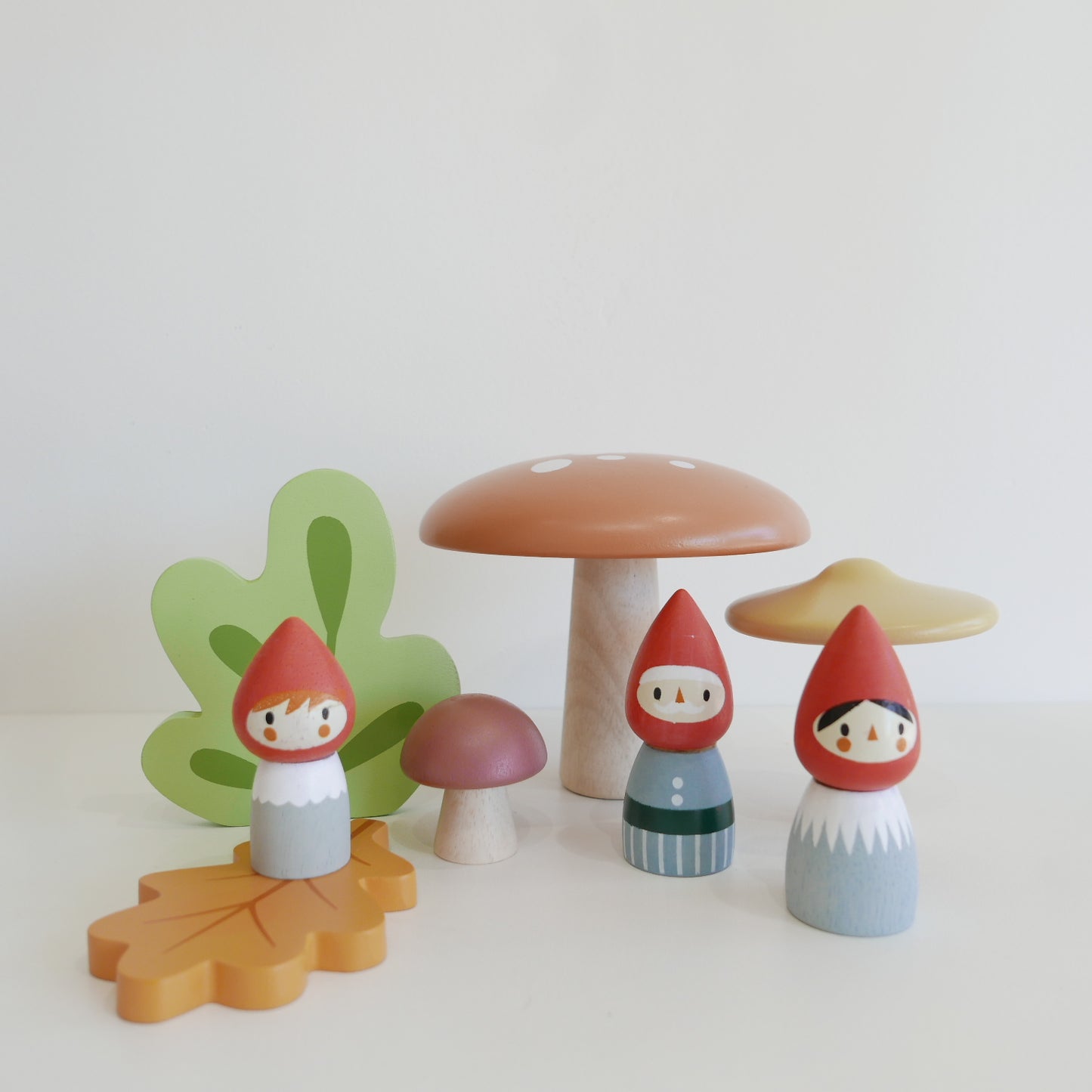 Wooden toy figures of gnomes and mushrooms 