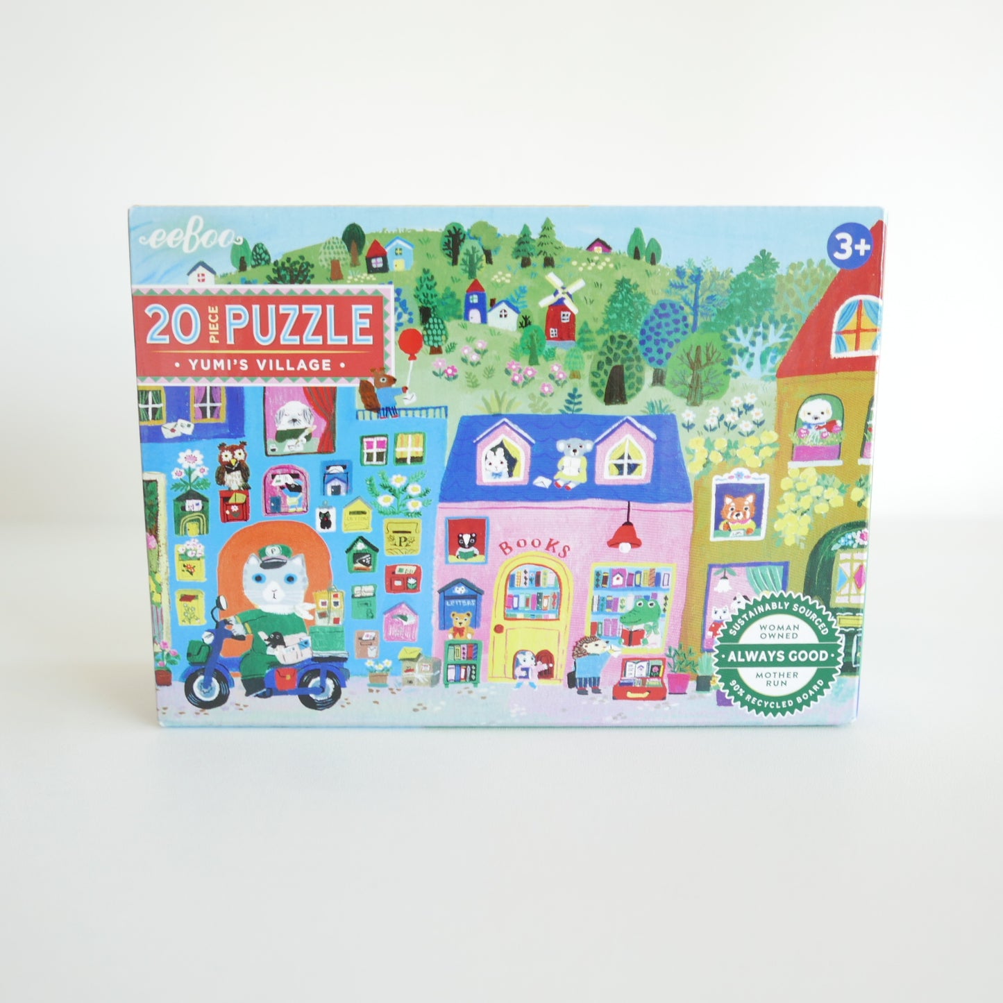 Children's puzzle box with a colorful village scene on a white background